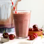 Cherry chocolate smoothie served with a straw.