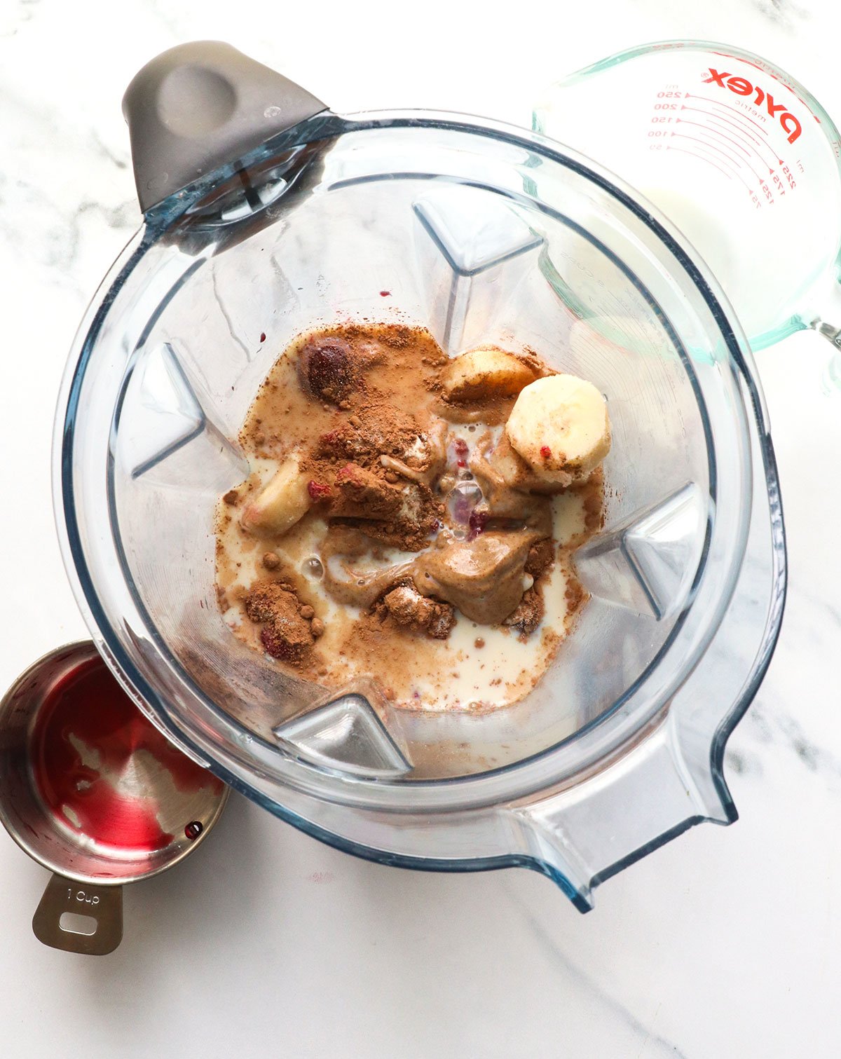 frozen cherries, almond butter, banana, milk, and cacao powder in a blender. 