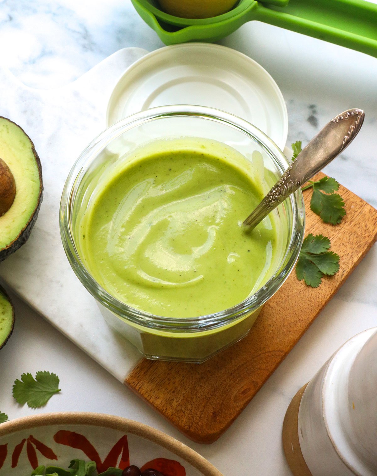 creamy avocado dressing in a glass jar with a spoon. - 2