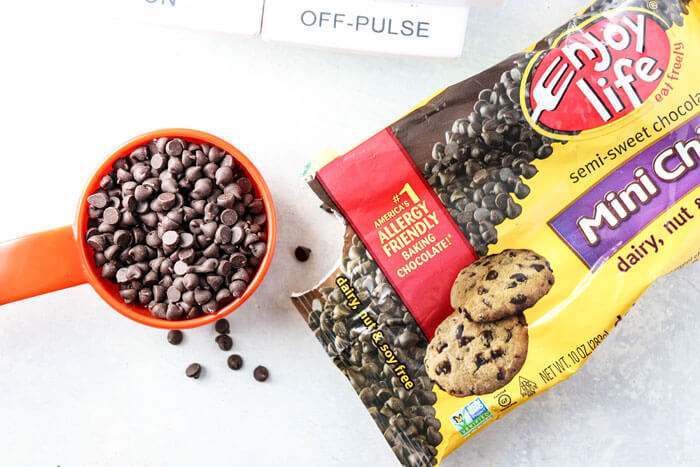 enjoy life chocolate chips in measuring cup with open bag next to it
