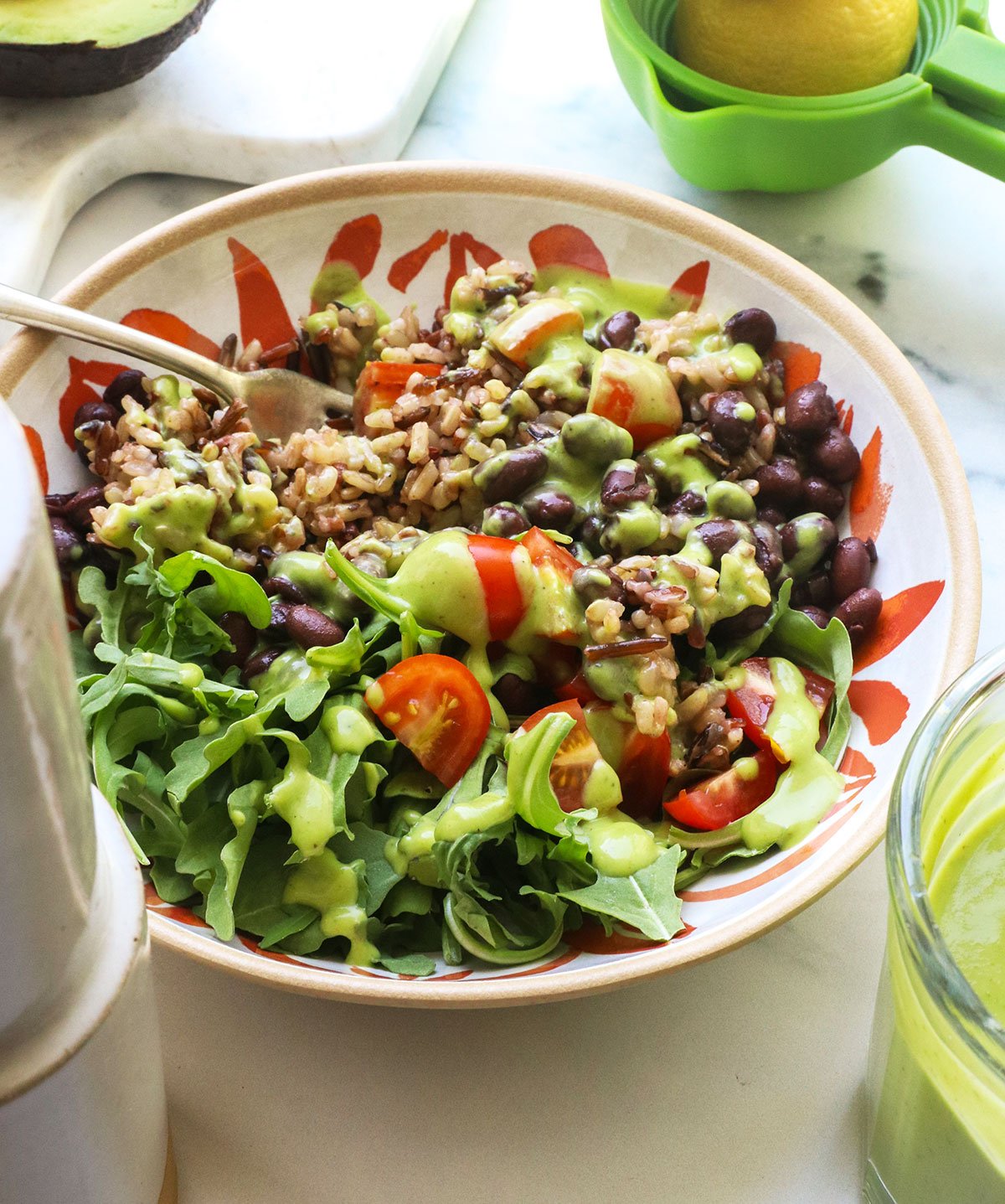 rice and bean bowl topped with creamy avocado dressing. - 6