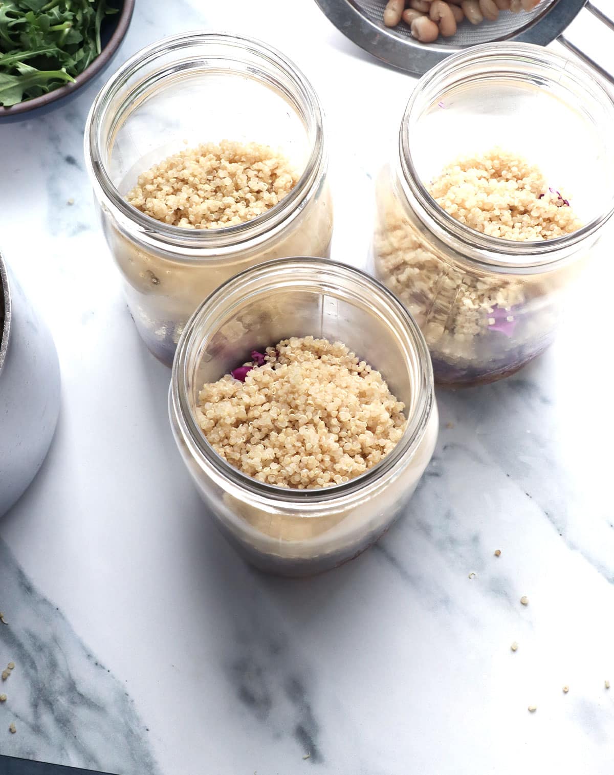 1/2 cup of quinoa added to 3 mason jars for salad. 
