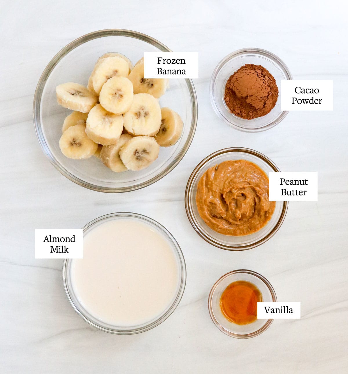 chocolate peanut butter banana smoothie ingredients in glass bowls.