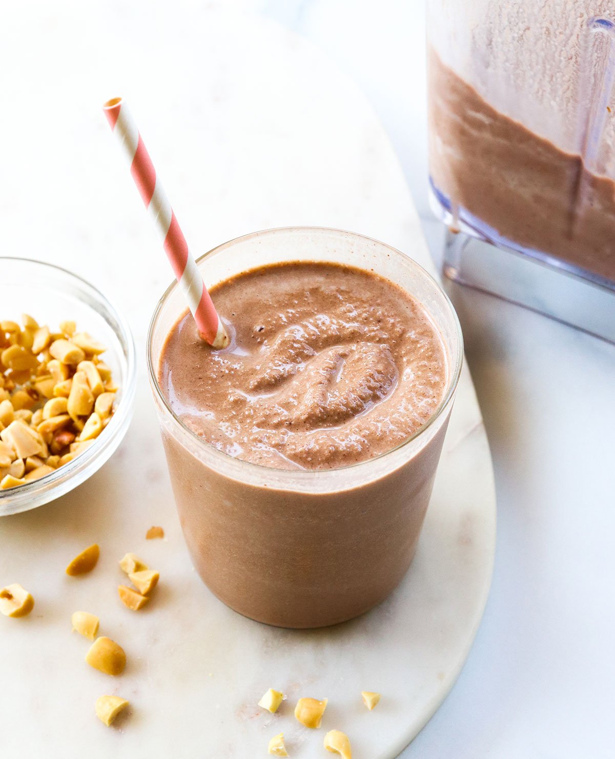 Chocolate peanut butter smoothie with a frosty texture in a glass.