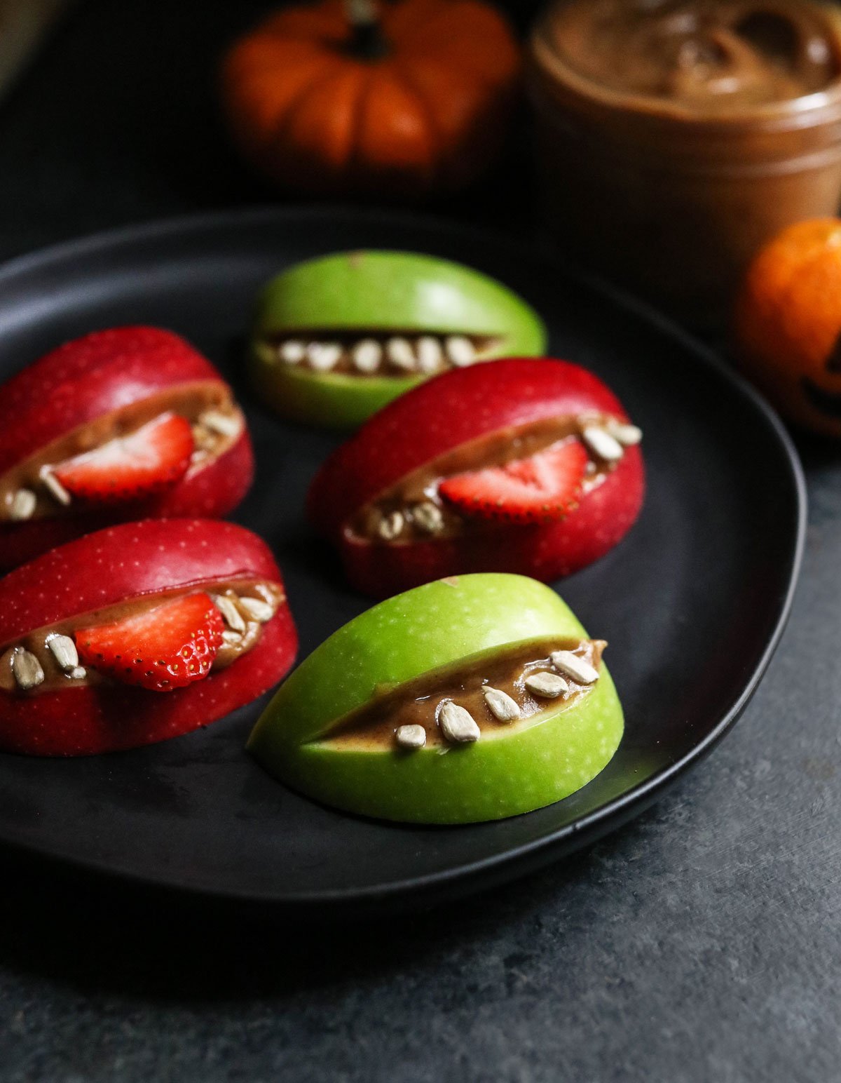 red and green apples sliced like monster mouths