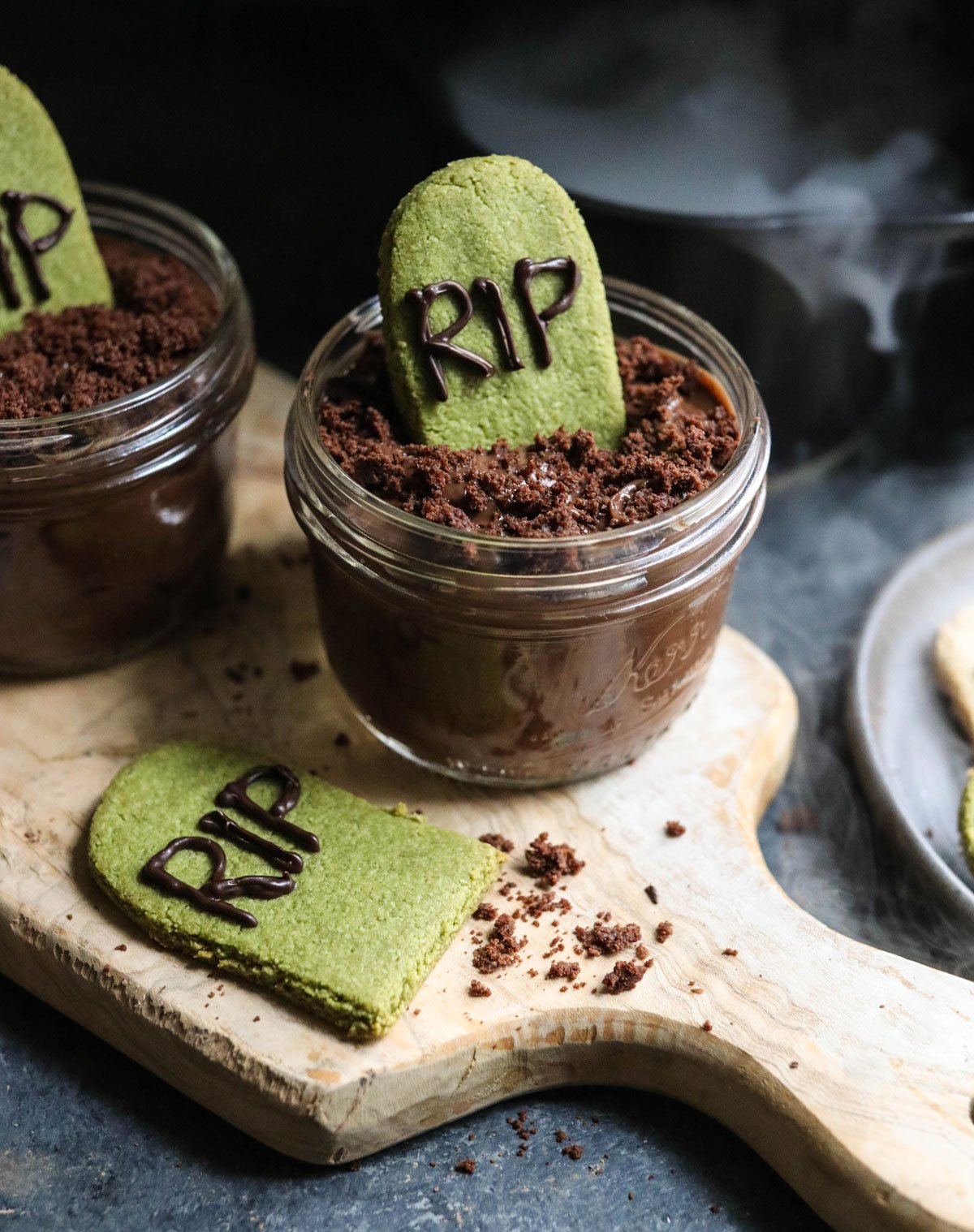 jar of chocolate pudding with tombstone cookie