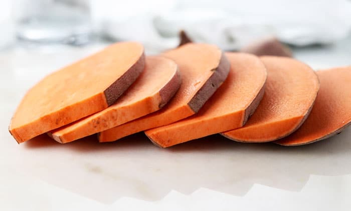 sliced sweet potatoes on white surface