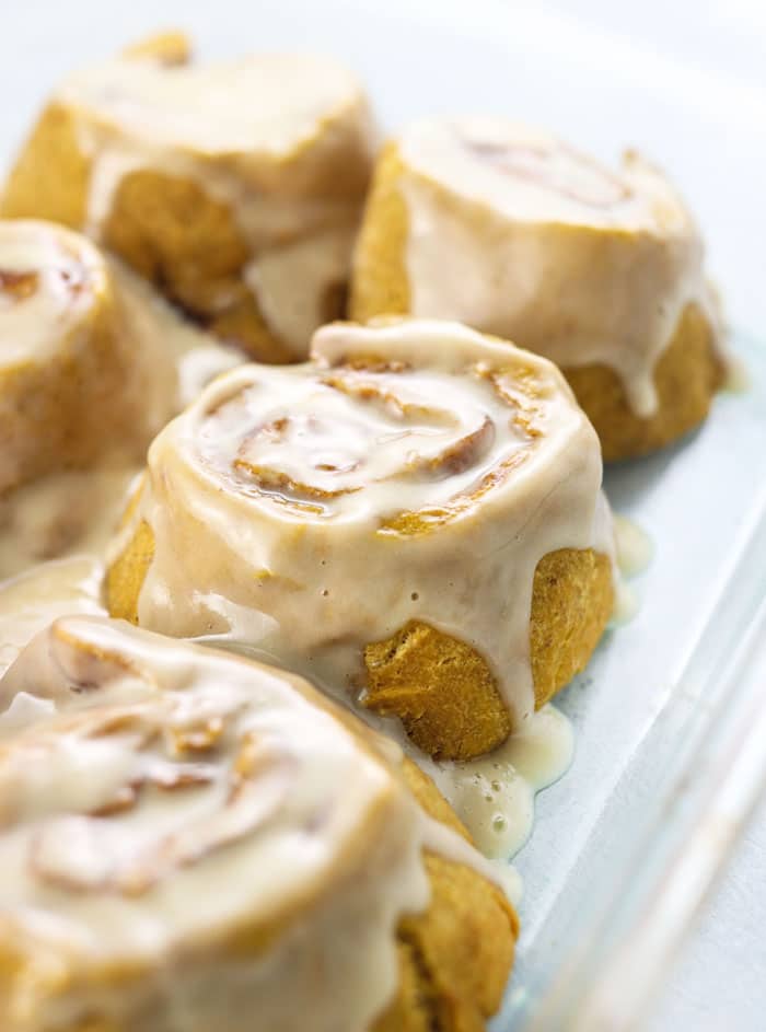 gluten-free vegan cinnamon rolls with icing in glass dish