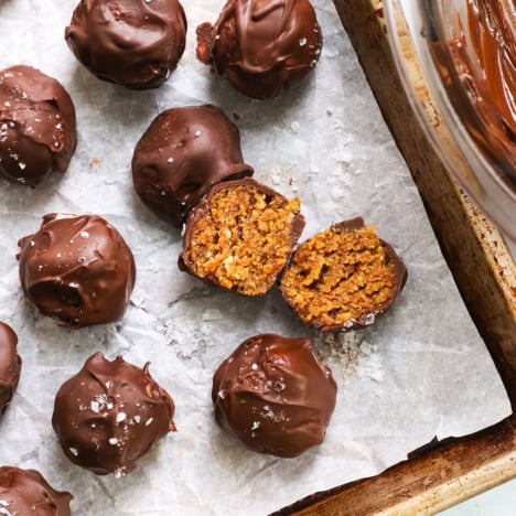 crispy peanut butter ball split in half on a pan.