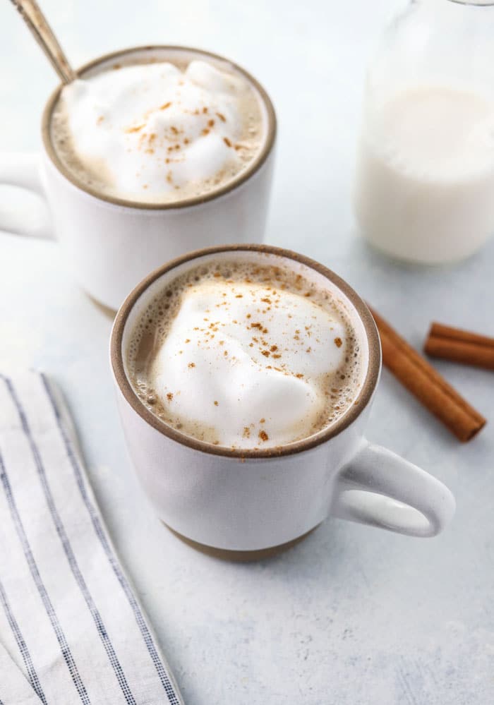 healthy chai latte recipe in two white mugs