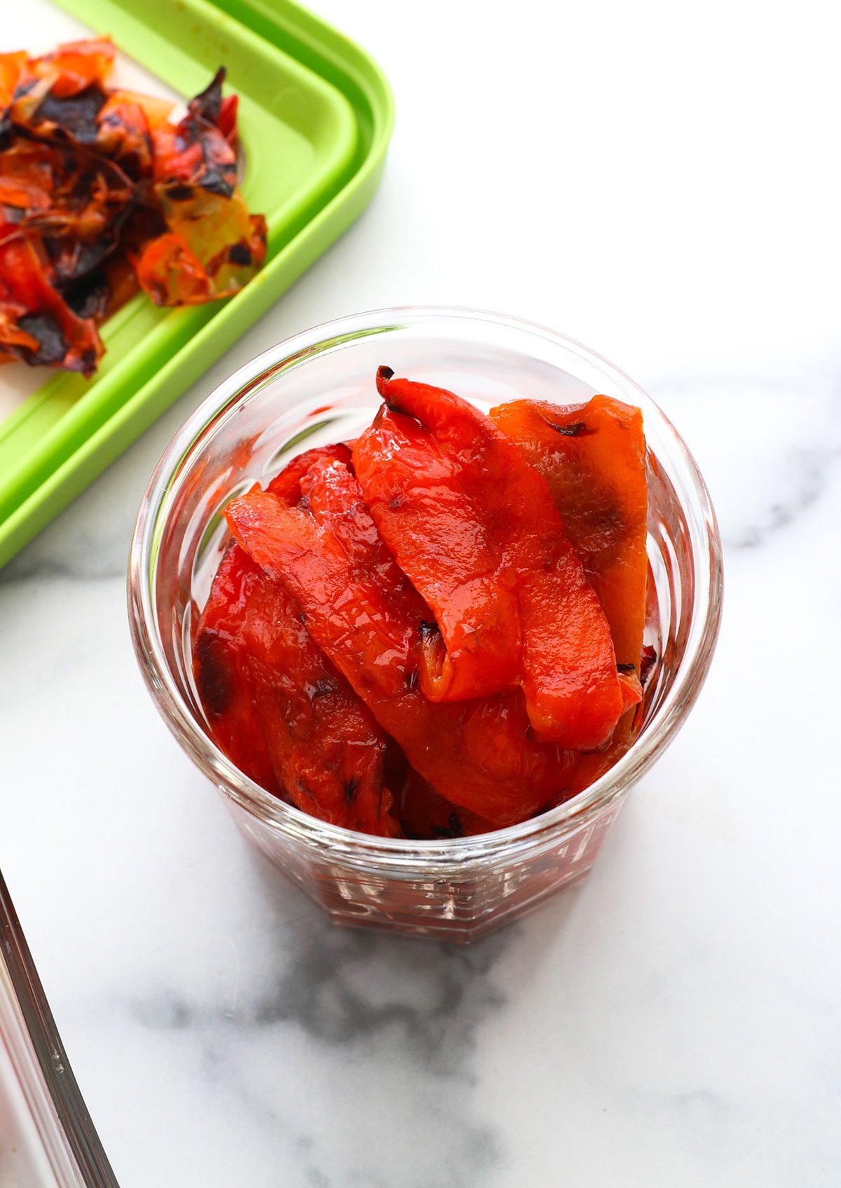 peeled roasted red peppers in a glass jar.