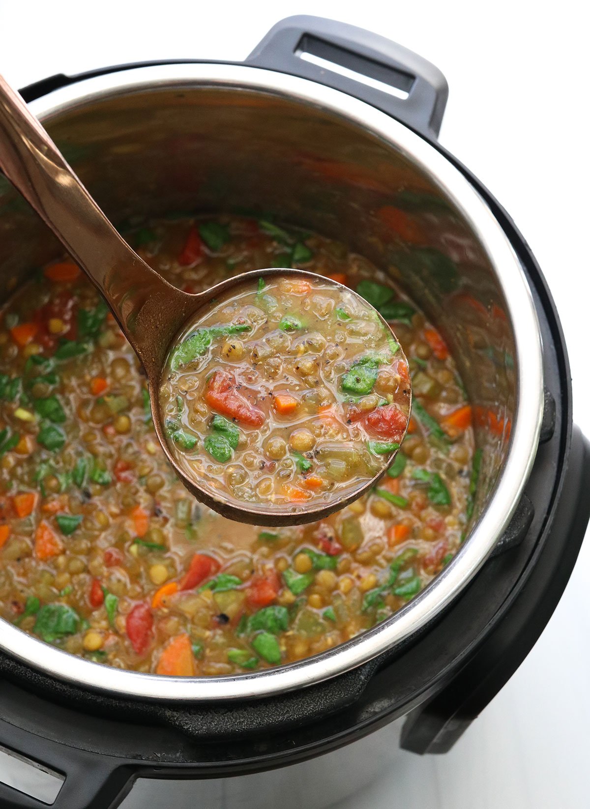 ladle full of Instant Pot lentil soup.
