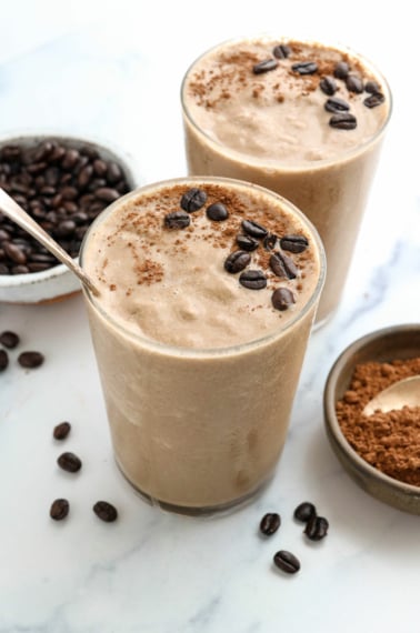 coffee smoothie in 2 glasses topped with coffee beans.