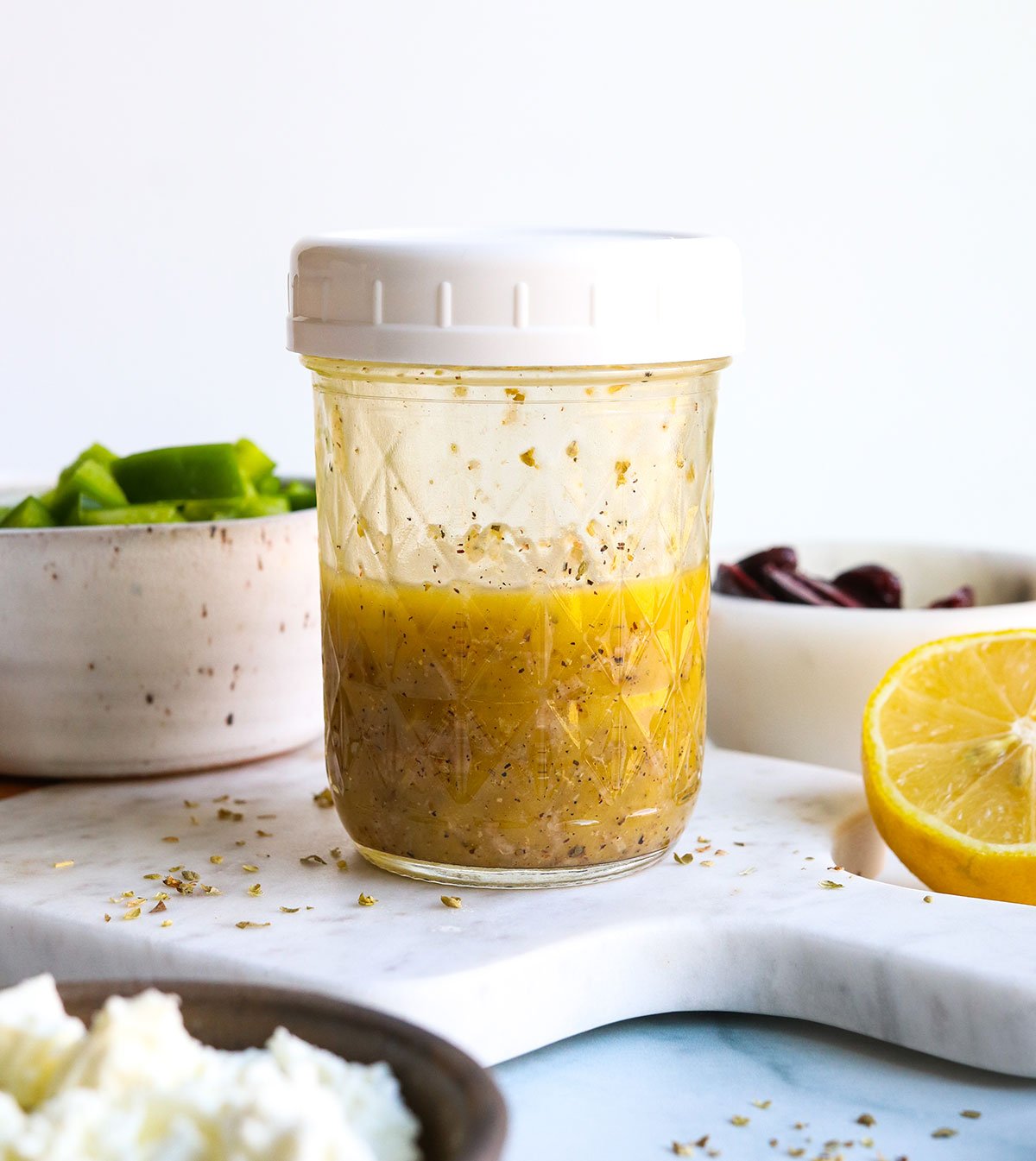 Mediterranean dressing mixed together in a glass jar with lid.