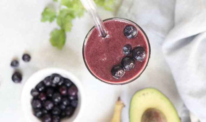 wild blueberry smoothie with straw