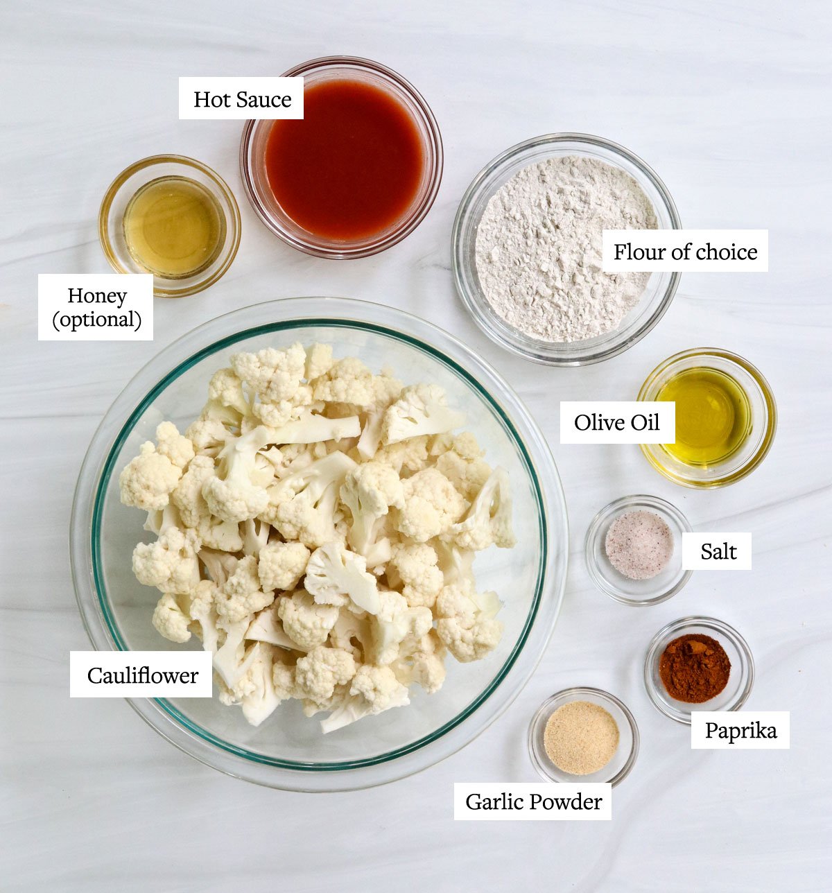 buffalo cauliflower ingredients labeled in glass bowls.