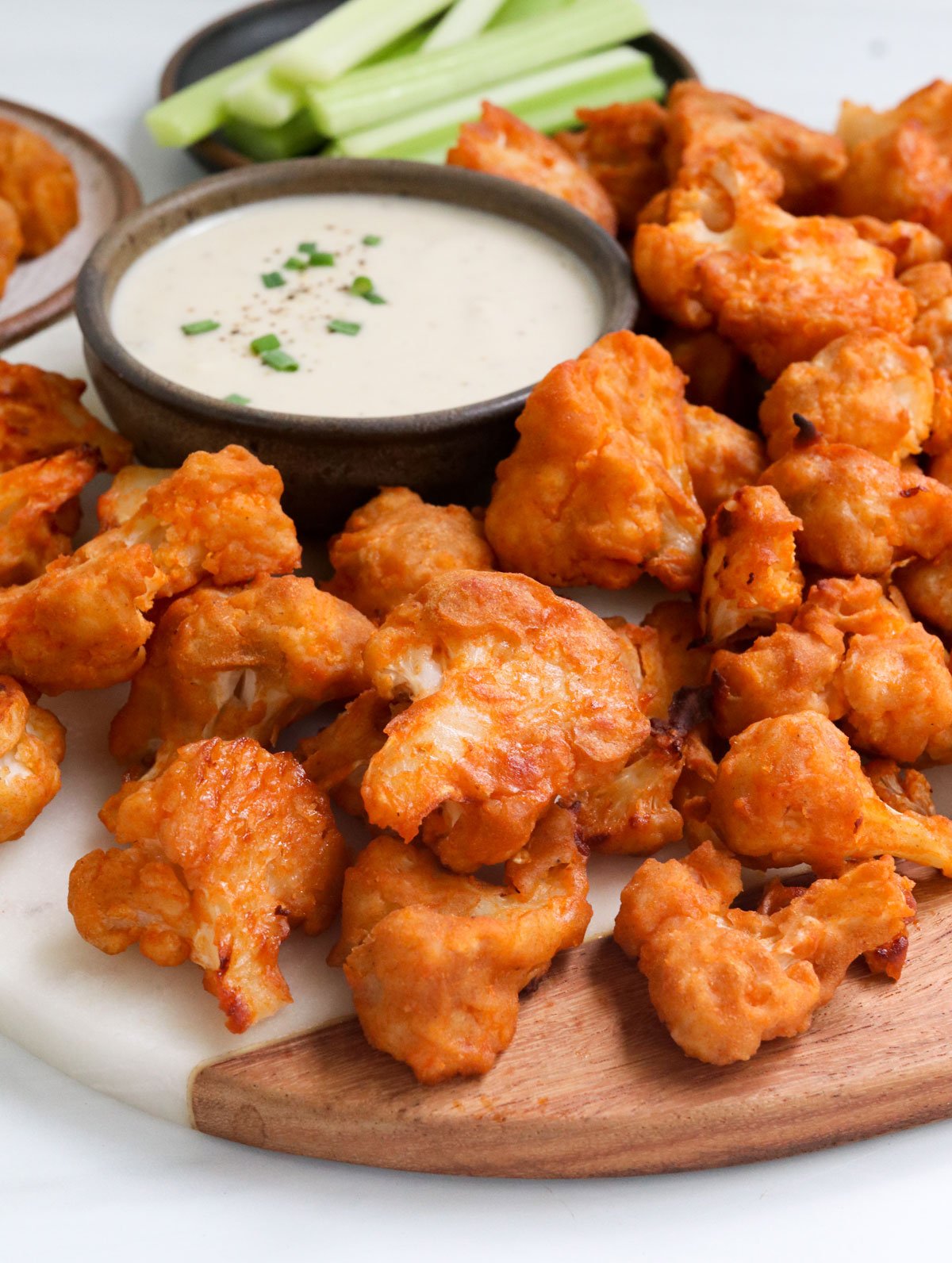 close up of buffalo cauliflower wings served with dip.