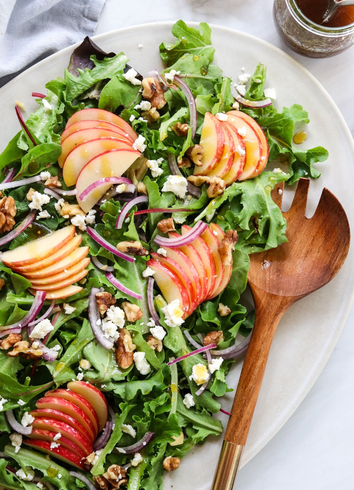 apple walnut salad served with wooden spork.