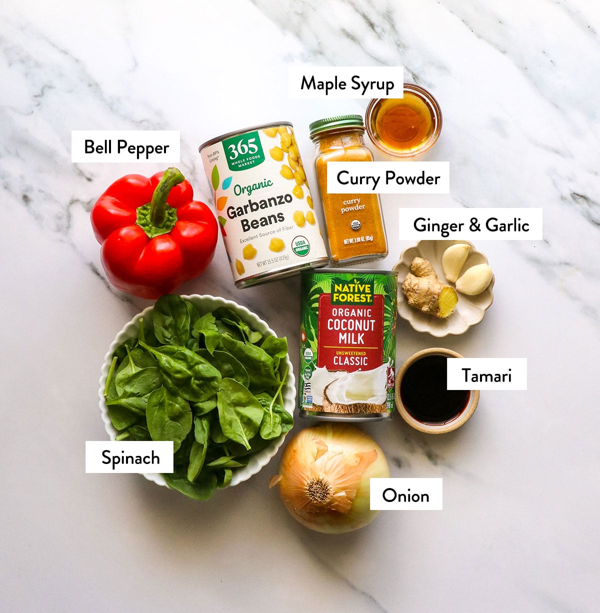 coconut milk, curry powder, chickpeas, spinach, and bell pepper labeled on a white surface.