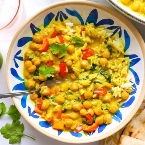 coconut curry served with chickpeas and spinach over white rice.