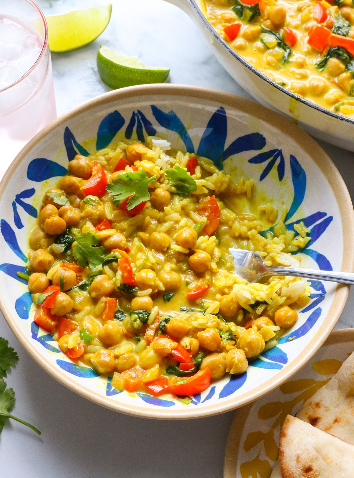 coconut curry in a bowl with veggies and white rice.