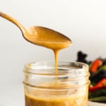 honey balsamic dressing dripping off a spoon.