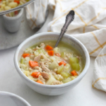 leftover turkey soup in a white bowl