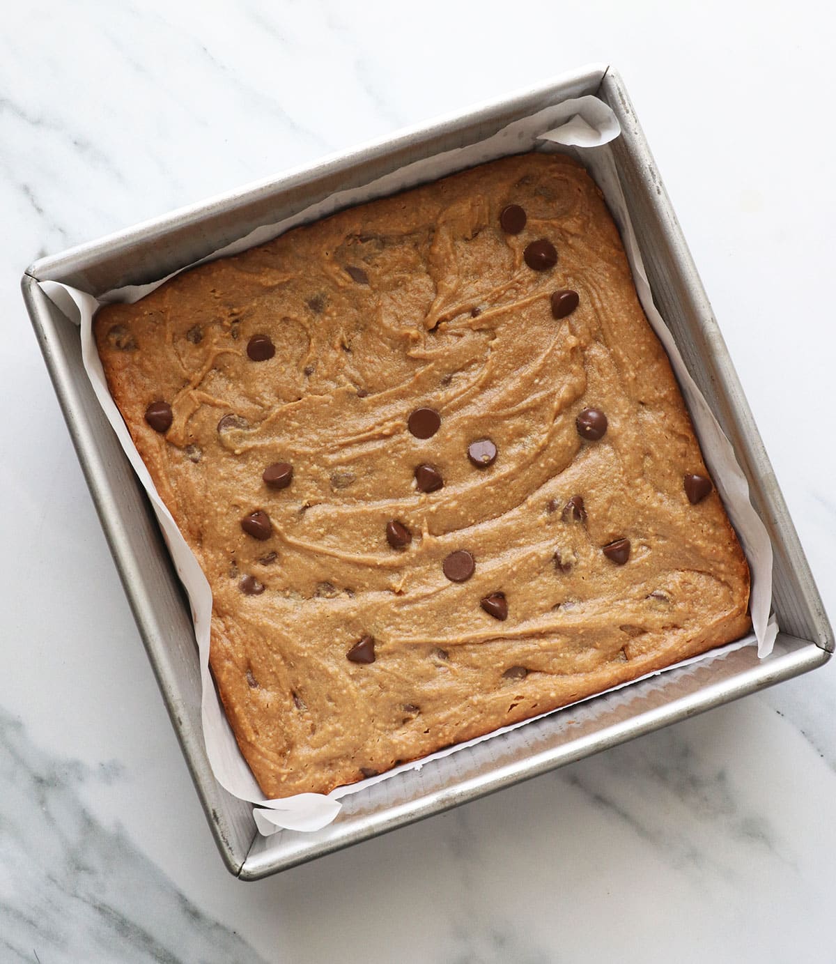 baked peanut butter blondies cooling in the square pan.