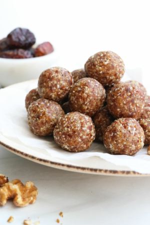date energy balls piled on a plate.