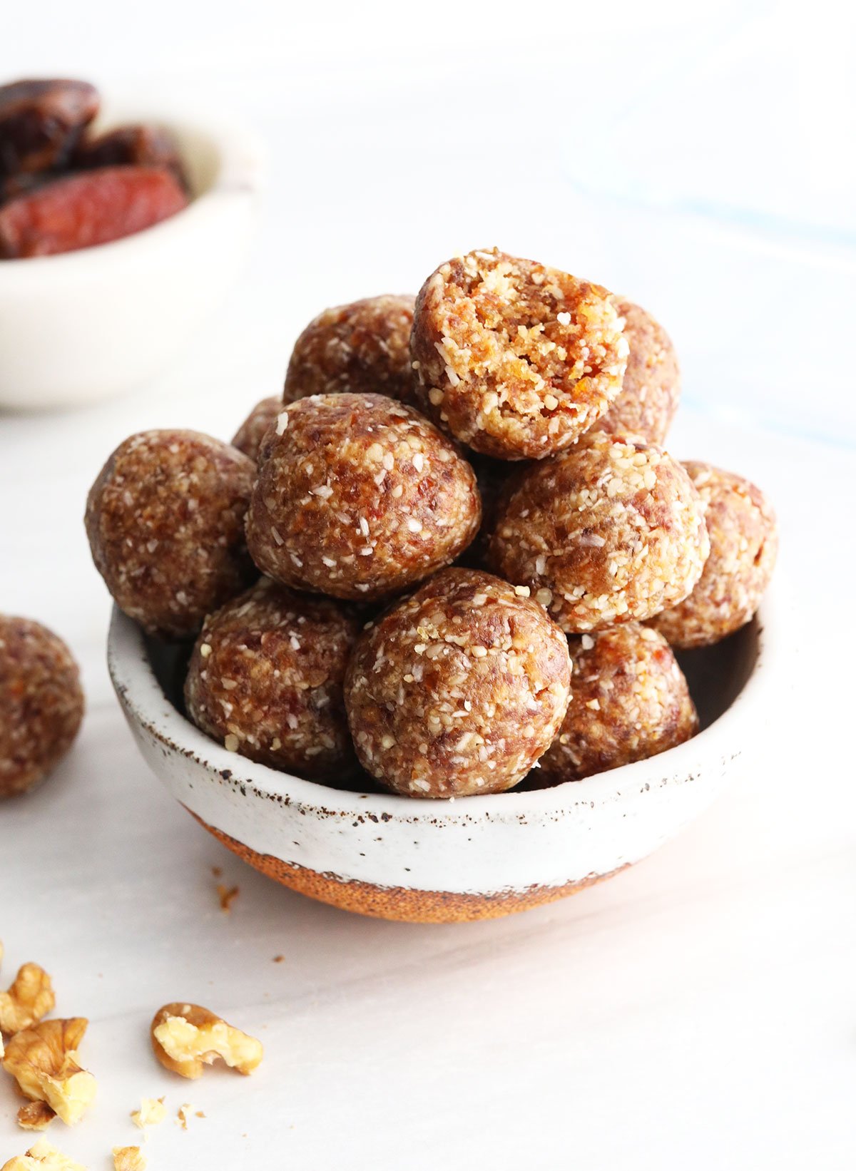 date balls in a bowl with a bite missing.