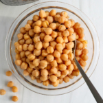 instant pot chickpeas in a glass bowl with spoon.