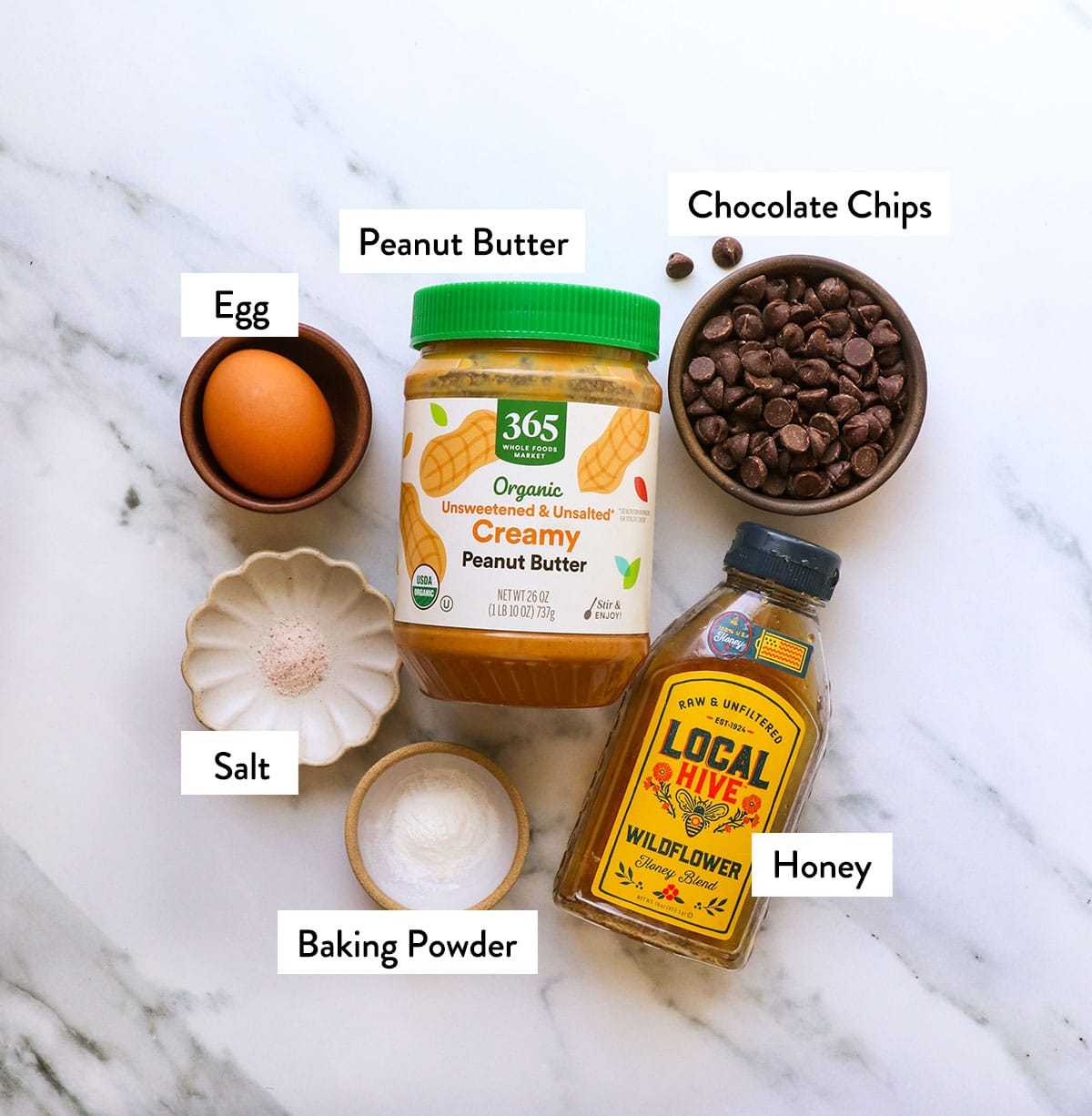 peanut butter, honey, chocolate chips, egg, baking powder, and salt in bowls.