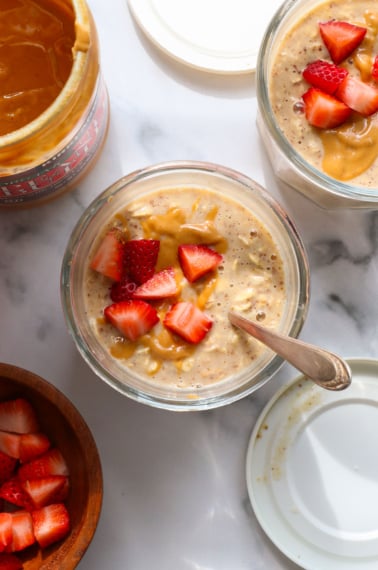 pb overnight oats topped with chopped strawberries.