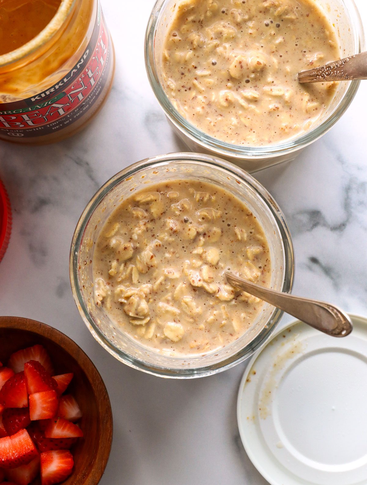 two jars of peanut butter overnight oats with the lids removed. 