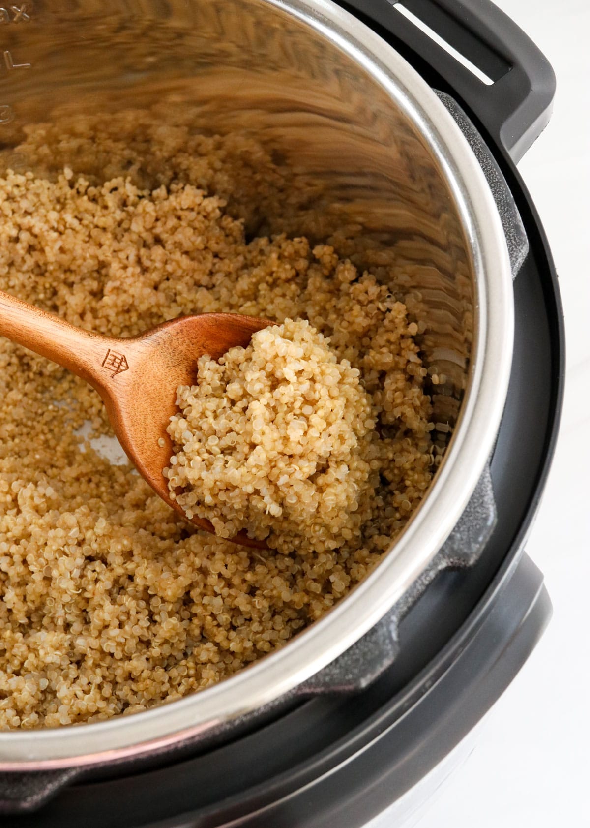 instant pot quinoa lifted up on a spoon.