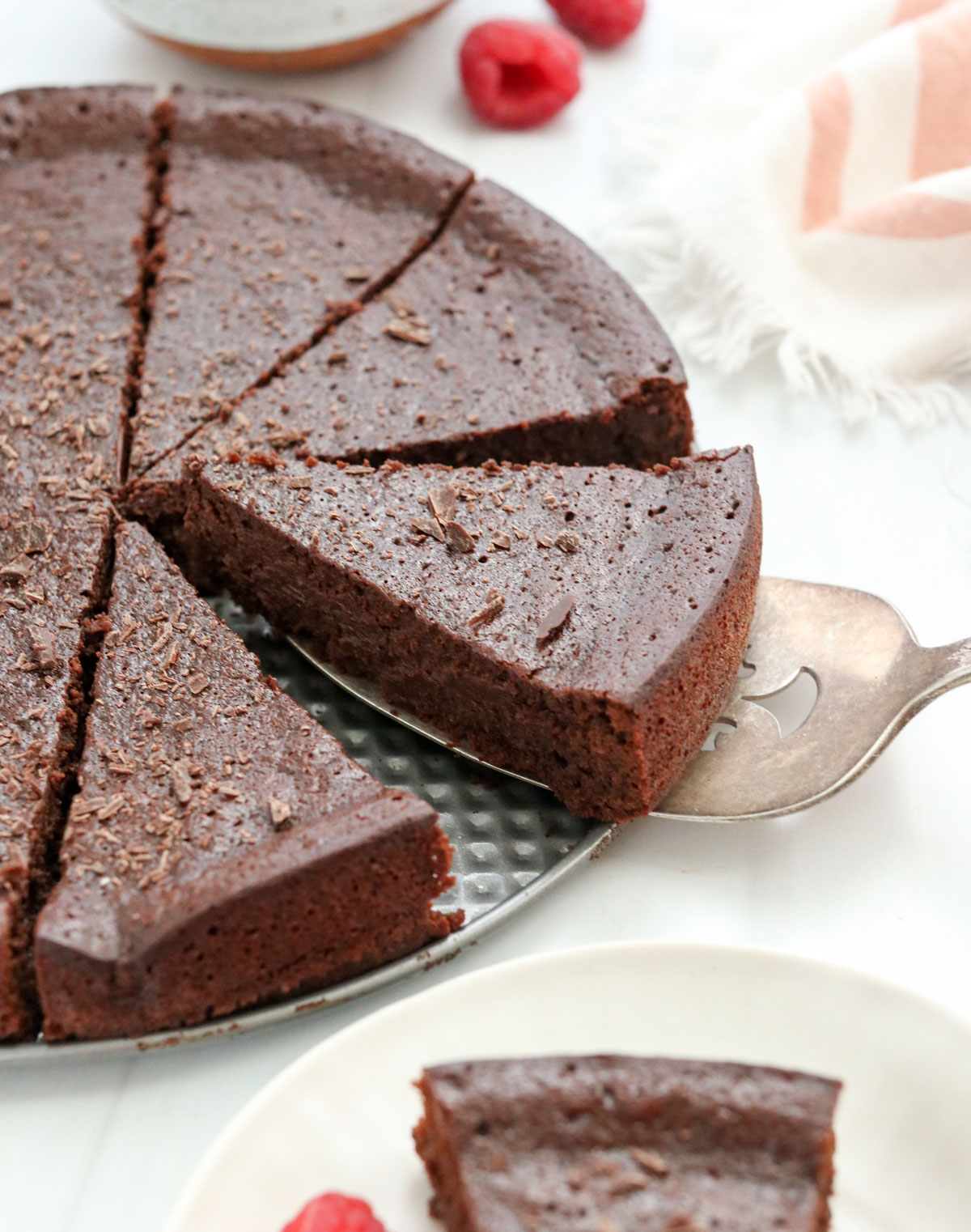 flourless chocolate cake sliced in pan.
