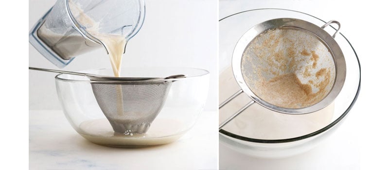 straining oat milk in mesh strainer