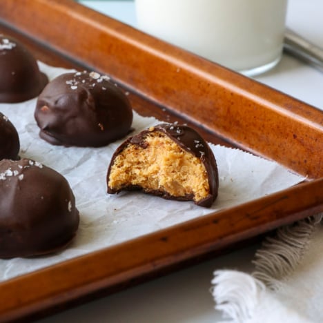 peanut butter ball with bite removed on a pan.