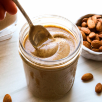 homemade almond butter stirred with a spoon.