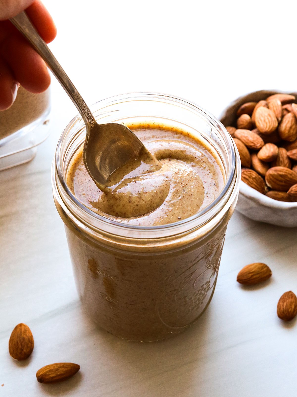 homemade almond butter stirred with a spoon.