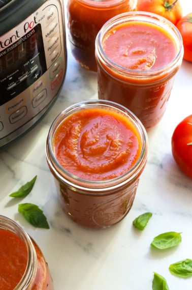 spaghetti sauce in glass jars by the Instant Pot.