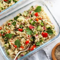 quinoa salad in two glass meal prep containers.