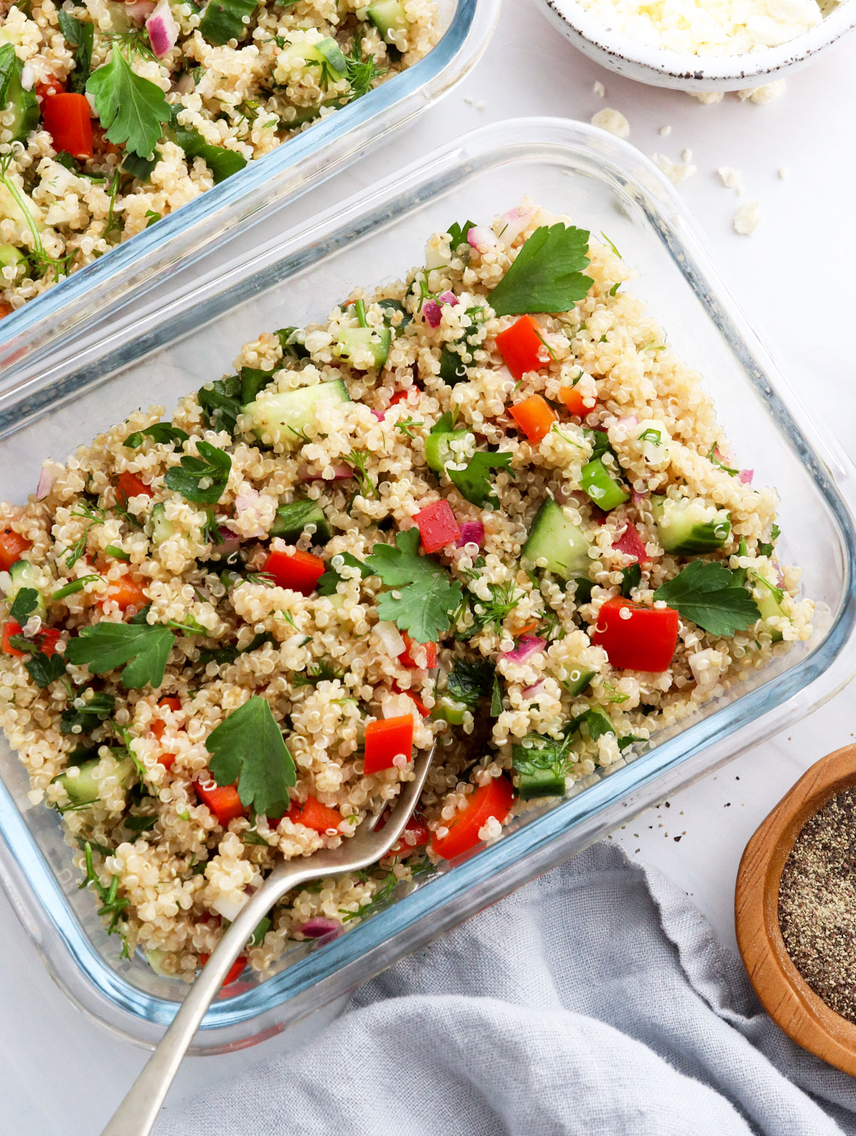 quinoa salad in two glass meal prep containers.