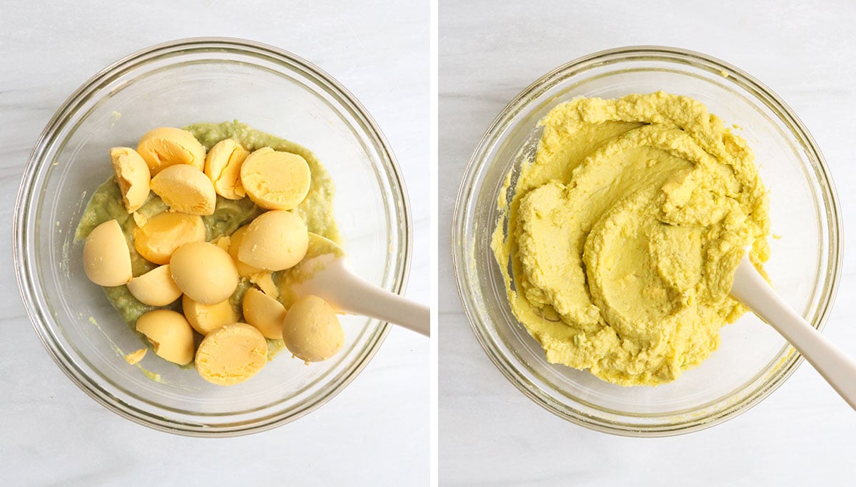 egg yolks mashed into deviled egg filling in glass bowl.