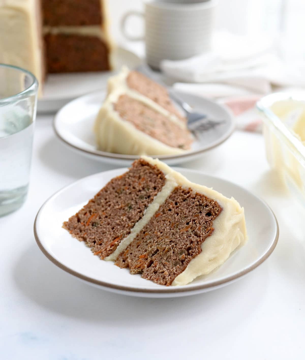 carrot cake slice on a plate with frosting