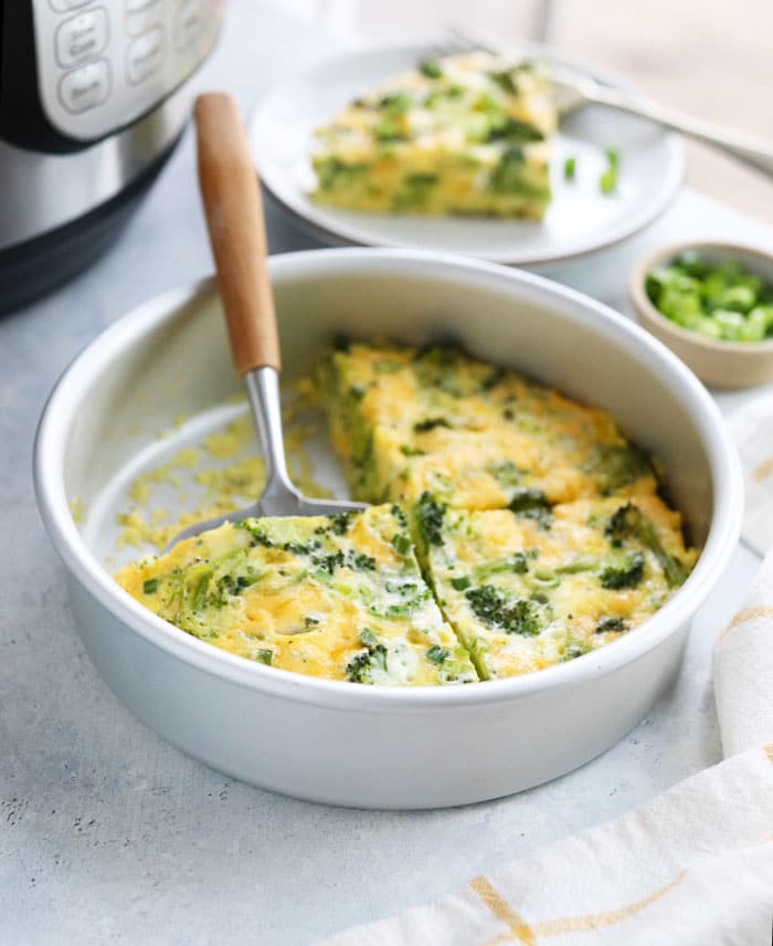 instant pot frittata sliced in pan with spatula for serving
