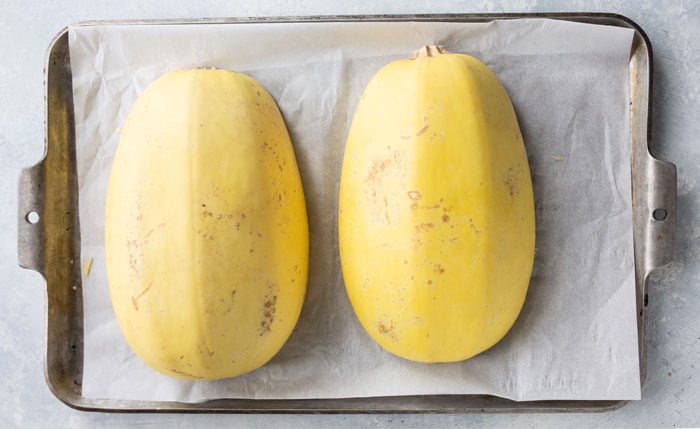 cut spaghetti squash on pan