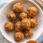 peanut butter protein balls in a white bowl labeled for pinterest.