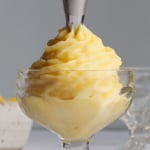 Pineapple whip is delivered from the icing bag to the plate.