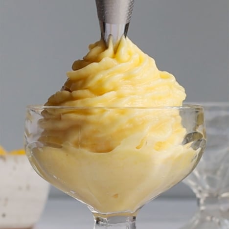 pineapple whip piped from a frosting bag into a dish.